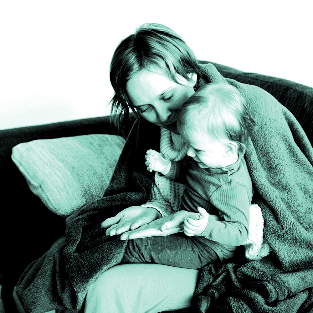 Lady sitting with son under a blanket